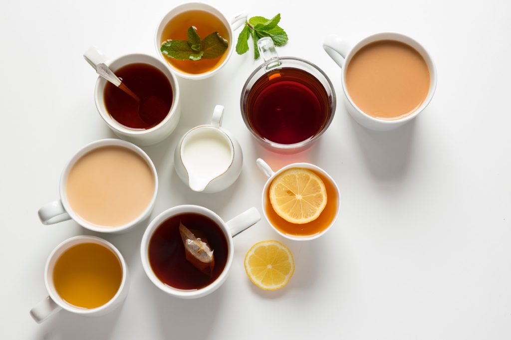 variety of cups filled with tea